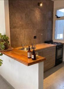 a kitchen with a counter with a sink and a stove at NuMa MAR in Puerto Madryn