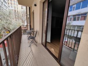 a balcony with a table and a chair at Mega Residence in Târgovişte