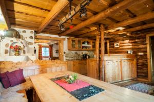 a kitchen with a wooden table in a cabin at Schröckhütte in Bad Hofgastein