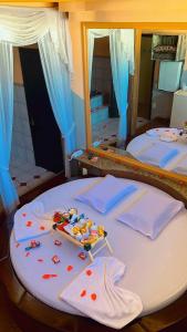 a bedroom with two beds and a large mirror at Motel Viva Vez in Canoas