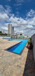 a swimming pool on the roof of a building at Flat 203 Red Sorocaba in Sorocaba