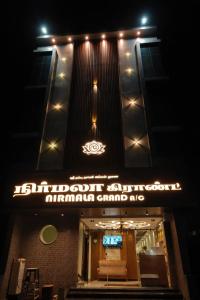 a sign on the front of a building at night at Nirmala Grand in Rāmeswaram