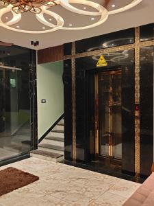 a lobby of a building with a door and a chandelier at Nirmala Grand in Rāmeswaram +9 photos