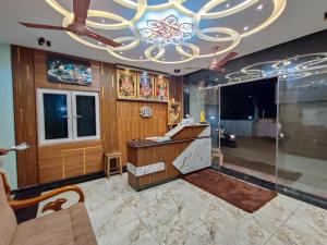 a large room with a chandelier and a lobby at Nirmala Grand in Rāmeswaram