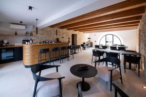 a restaurant with tables and chairs and a bar at Agriturismo Il Borghetto in Montedinove