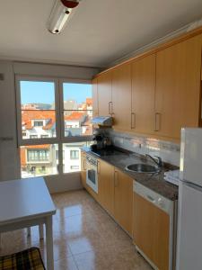 a kitchen with a sink and a large window at Atalaya 5 - VUT5463AS in Ribadesella