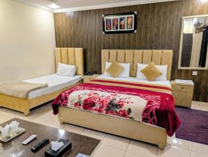a bedroom with two beds in a room at Royal Fort Executive Hotel Gulberg in Lahore