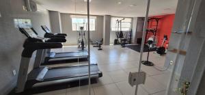 a gym with treadmills and ellipticals in a room at Flat 203 Red Sorocaba in Sorocaba