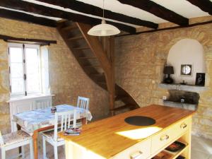 a dining room with a table and a staircase at Gîtes Coeur de Lot in Soucirac
