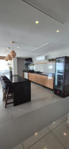 a kitchen with a black island in a room at Flat 203 Red Sorocaba in Sorocaba