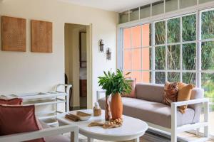 a living room with a couch and a table at Spacious Villa in La Cuaba, Pool in Pedro Brand