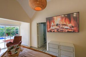 a living room with a large painting on the wall at Spacious Villa in La Cuaba, Pool in Pedro Brand