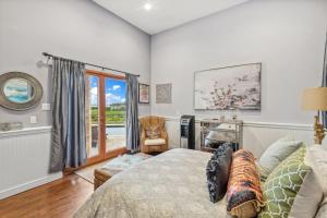 a bedroom with a bed and a desk at Hamptons Romantic Waterfront Queen Suite in Remsenburg +19 photos