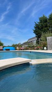 a swimming pool with a bench in the water at Hamptons Romantic Waterfront Queen Suite in Remsenburg