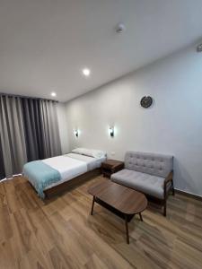 a bedroom with a bed and a couch and a table at MSResort Panglao in Looc +23 photos