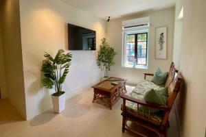 a living room with a couch and a table at NEW RENOVATION - Beachside Two-Bedroom Suite in Savaneta