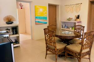 a dining room with a glass table and chairs at NEW RENOVATION - Beachside Two-Bedroom Suite in Savaneta