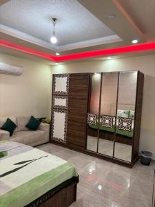 a bedroom with a bed and a couch in a room at الوليد للشقق المفروشة in Amman