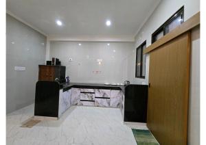 a bathroom with a counter and a sink in a room at SHREE RAMA Niwasam in Ayodhya