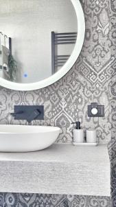 a bathroom with a white sink and a mirror at Terra & Salt in Bibinje