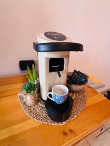 a coffee maker sitting on top of a table at Edelweiss Pila-Ski appartment con vista montagne in Pila
