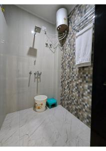 a bathroom with a shower with a camera on the wall at SHREE RAMA Niwasam in Ayodhya +14 photos