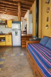 a bedroom with a bed and a kitchen with a stove at Casa Atardecer San Javier in San Javier