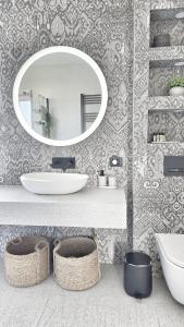 a bathroom with a white sink and a mirror at Terra & Salt in Bibinje
