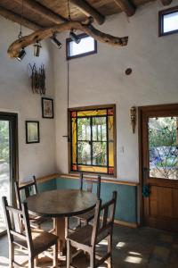 a dining room with a table and chairs and stained glass windows at Casa Atardecer San Javier in San Javier +15 photos