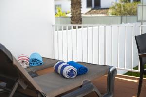 a patio table with blankets and pillows on it at Mouraliz Apartments by HD PROPERTIES - Vilamoura Marina in Vilamoura +45 photos