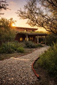 a house with a gravel road in front of it at Casa Atardecer San Javier in San Javier