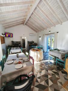 a dining room with tables and chairs in a room at Monte do Sol in São Luis