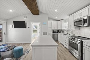 a kitchen with white cabinets and a counter top at Chulavista Cozy Close to beach in Galveston