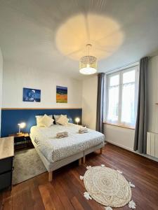 a bedroom with a bed and a large window at T2 Amboise avec vue sur le Château Royal in Amboise