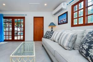a living room with a couch and a glass table at Beachfront Two-Bedroom Villa in Savaneta