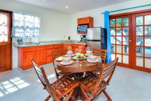 a kitchen with a wooden table with wine glasses on it at Beachfront Two-Bedroom Villa in Savaneta +49 photos