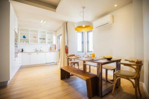 a kitchen and dining room with a table and chairs at The Salty Lodge in Lagos