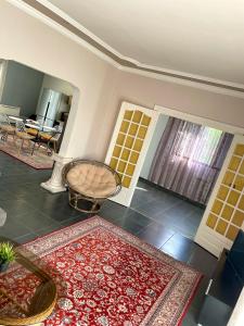 a living room with red rugs on the floor at Maison de vacances campagnes in La Celle-Guénand
