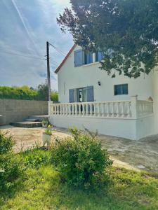 a white house with a white fence in front of it at Maison de vacances campagnes in La Celle-Guénand