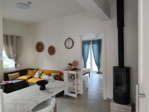 a living room with a couch and a stove at NMD house in Ermioni