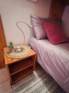 a lamp on a table next to a bed at Edelweiss Pila-Ski appartment con vista montagne in Pila