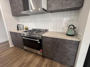 a kitchen with a stove and a tea kettle at Urban Pause - Donnybrook in Donnybrook
