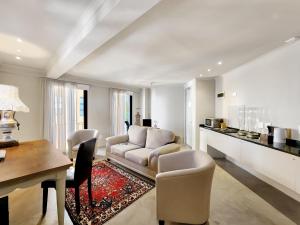 a living room with a couch and a table at Rouge on Rose Boutique Hotel in Cape Town