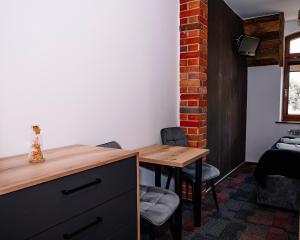a dining room with a wooden table and chairs at Dworek Galosa in Stronie Śląskie +120 photos