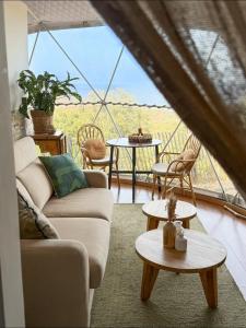 a living room with a couch and a table at Domaine de Sonia - Logements éco-insolites in Porto-Vecchio