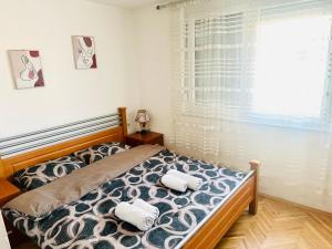 a bedroom with a bed with two towels on it at Centar Apartment in Kumanovo