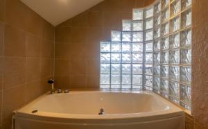 a bath tub in a bathroom with a window at Malee Beach F3 in Phra Ae beach +19 photos