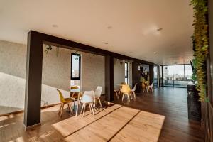 a living room with a table and chairs in a building at Hotel QC in Trujillo