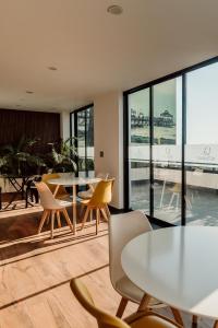a cafeteria with tables and chairs and a view of the ocean at Hotel QC in Trujillo +35 photos