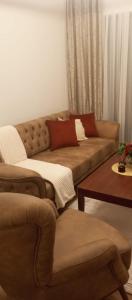 a living room with a couch and a table at Ruza Vetrova a4 in Nova Varoš